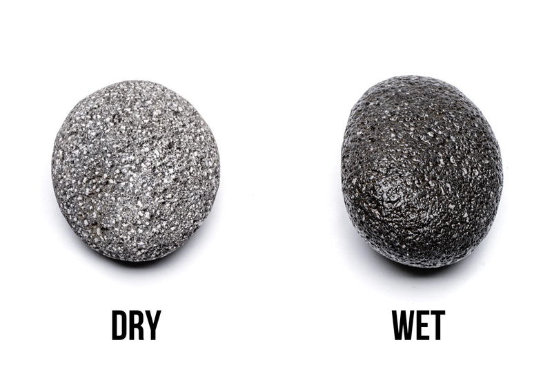 Black UNSHARDSCAPE Star Lava Rock stone featuring a dark, porous surface ideal for decorative or gardening use.