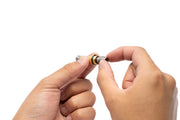 UNSCO2 CO2 solenoid spring switch replacement accessory showing a compact metallic switch part for CO2 systems.