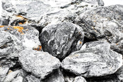 UNSHARDSCAPE Cueva Stone showing textured natural stone surface for landscaping or decorative use.