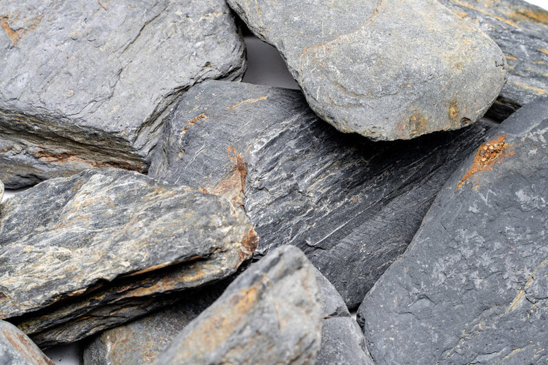 Dark blue slate stone from UNSHARDSCAPE with a smooth, natural surface and rich color, ideal for landscaping or decorative use.