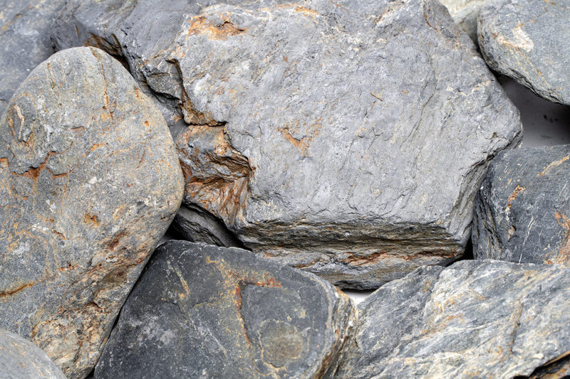 Dark blue slate stone from UNSHARDSCAPE, showing textured natural surface suitable for landscaping and decorative use.