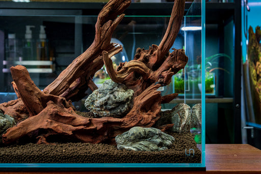 Malaysian driftwood from UNSHARDSCAPE, showing natural, weathered wood with intricate textures and organic shapes suitable for decor.