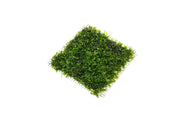 Close-up of IS Pearl Moss on stainless steel, showcasing lush moss with pearl-like accents on a sleek metal surface.
