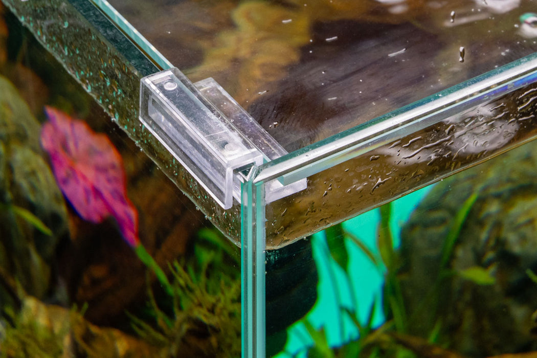 Pair of Ultum Nature Systems rimless aquarium lid clips used to secure glass lids on a rimless fish tank.