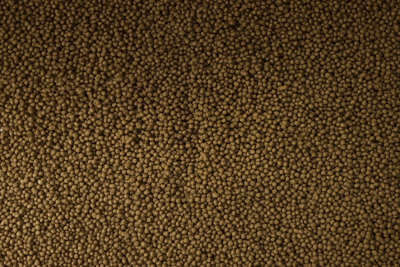 Ultra Fresh Goldfish Premium Pellet fish food in a clear container, showing golden pellets designed for goldfish nutrition.