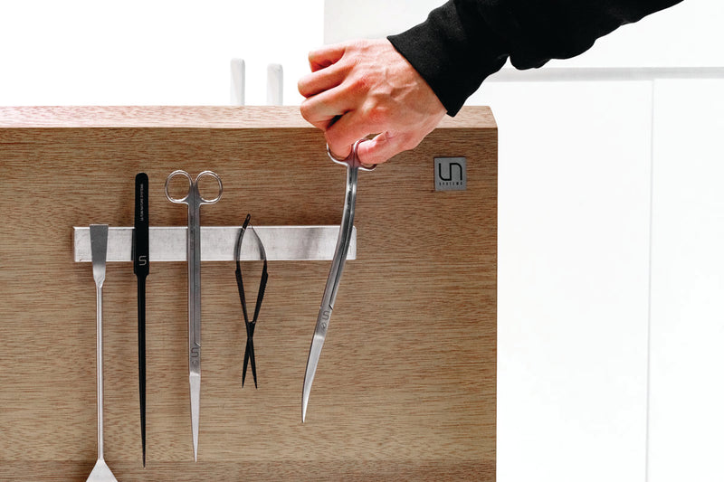 UNSTOOLS UNS Magnetic Tool Bar accessory with multiple slots for holding metal tools and accessories.