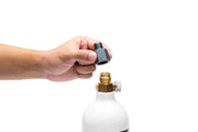 UNS Micro CO2 paintball adapter attached to a paintball gun for easy CO2 tank connection and operation.