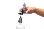 UNS Micro CO2 paintball adapter attached to a paintball gun for efficient CO2 gas transfer.