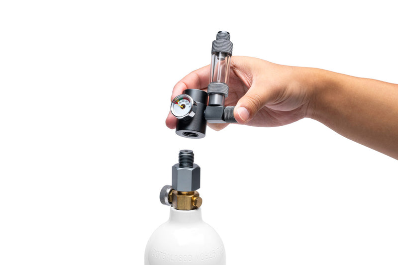 UNS Micro CO2 paintball adapter attached to a paintball gun for efficient CO2 gas transfer.