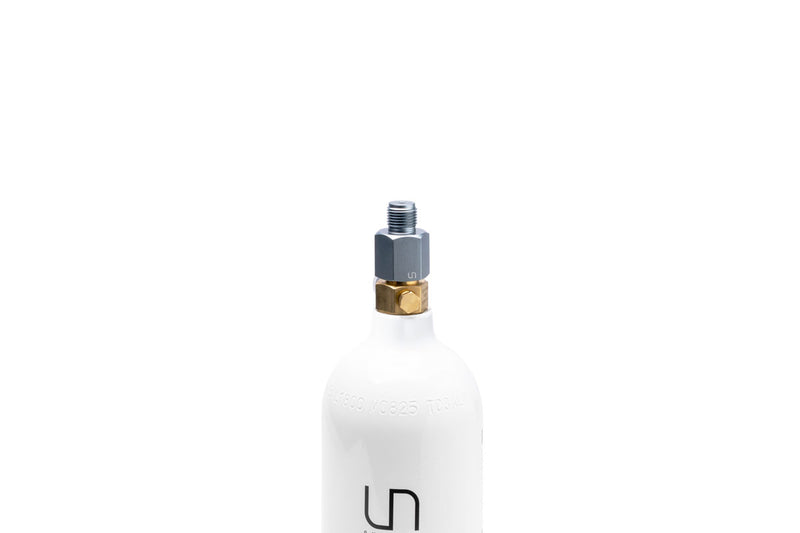 UNS Micro CO2 paintball adapter showing compact design and threaded connection for easy attachment to paintball equipment.
