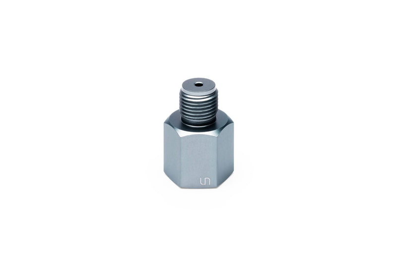 UNS Micro CO2 Paintball Adapter attached to a paintball gun for CO2 cartridge connection, compact and lightweight design.