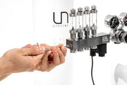 UNS Pro CO2 manifold block for controlled gas distribution, featuring multiple connectors on a durable metal body.