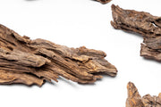 Small piece of natural forest driftwood by UNSBONSAI, showcasing its weathered texture and organic shape.