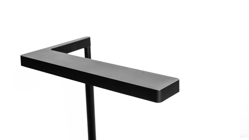 ONF Flat Nano Stand LED light on a desk, compact lighting device with adjustable stand for photography or video illumination.
