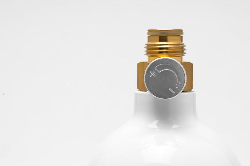 UNSCO2 16 oz. CO2 paintball cylinder with valve, used for powering paintball guns, shown in a close-up image.