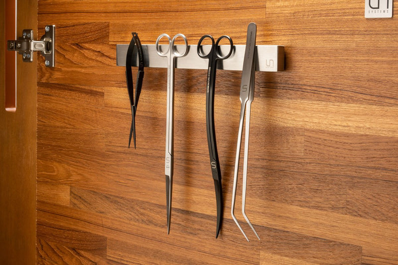 UNSTOOLS UNS Magnetic Tool Bar accessory with magnetic strips holding metal tools and accessories on a work surface.